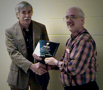 Dr. Harry Perlstadt, Commissioner, presenting a commemorative plaque to Dr. Jim Sherohman, Director of the first Applied Sociology program to be accredited Dr. Harry Perlstadt, Commissioner, presenting a commemorative plaque to Dr. Jim Sherohman, Director of the first Applied Sociology program to be accredited